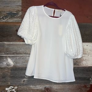 Brand new with tags! Beautiful white blouse with sequin sleeve detail.